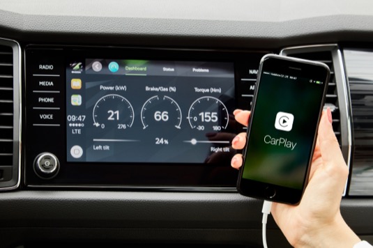 Aniž by bylo nutné ovládat smartphone, může řidič na velkém displeji ve voze vybírat jednotlivé funkce aplikace Škoda OneApp pohodlně dotykem prstu.