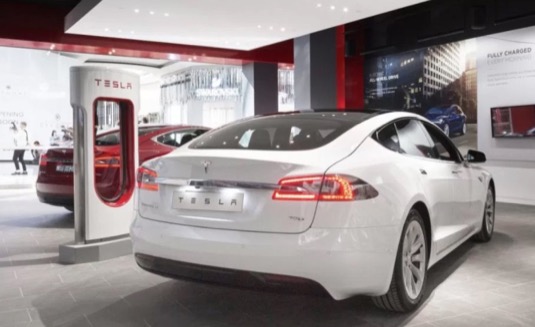 auto elektromobily Tesla Model S v obchodu Store u nabíječky Supercharger